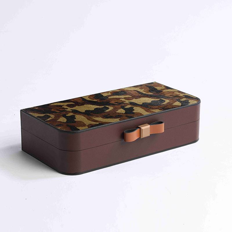 A metal leather tray in a bed-bed-head closet in a pony-skin-coated box box