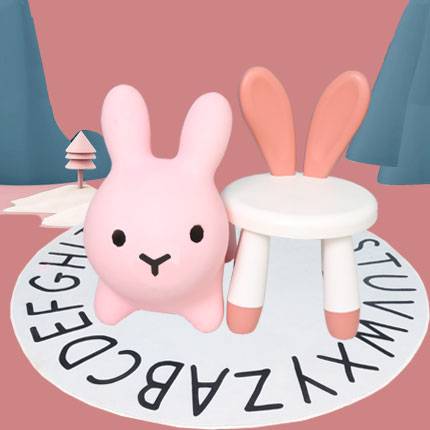 A thick pink rabbit with a thick coral rabbit chair