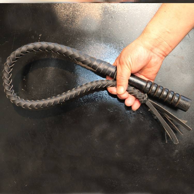One metre of black, pure oxen lashes, wooden handle
