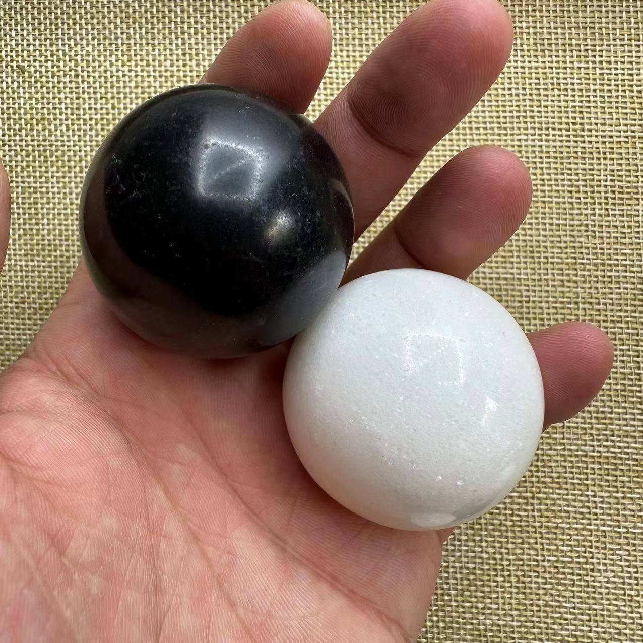 a pair of black stone and white jade, around 42mm