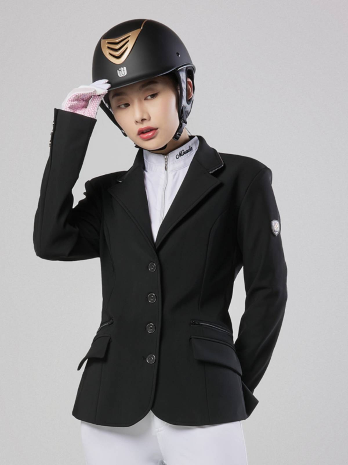 An adult child with a special equipment for a horsesuit with British-style impairments rides a knight's suit in a horse racing suit