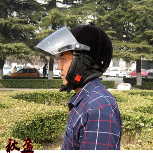 A horse riding a velvet helmet outdoors to protect the summer helmet lady