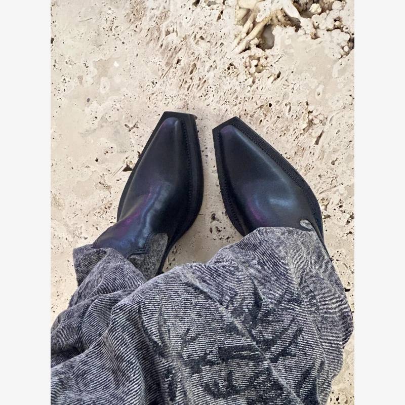 Black and gray cowboy rags with sharp boots and high western cowboy boots