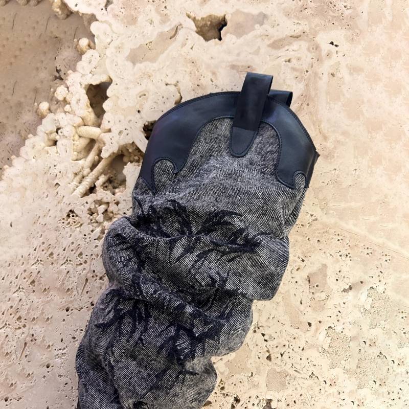 Black and gray cowboy rags with sharp boots and high western cowboy boots