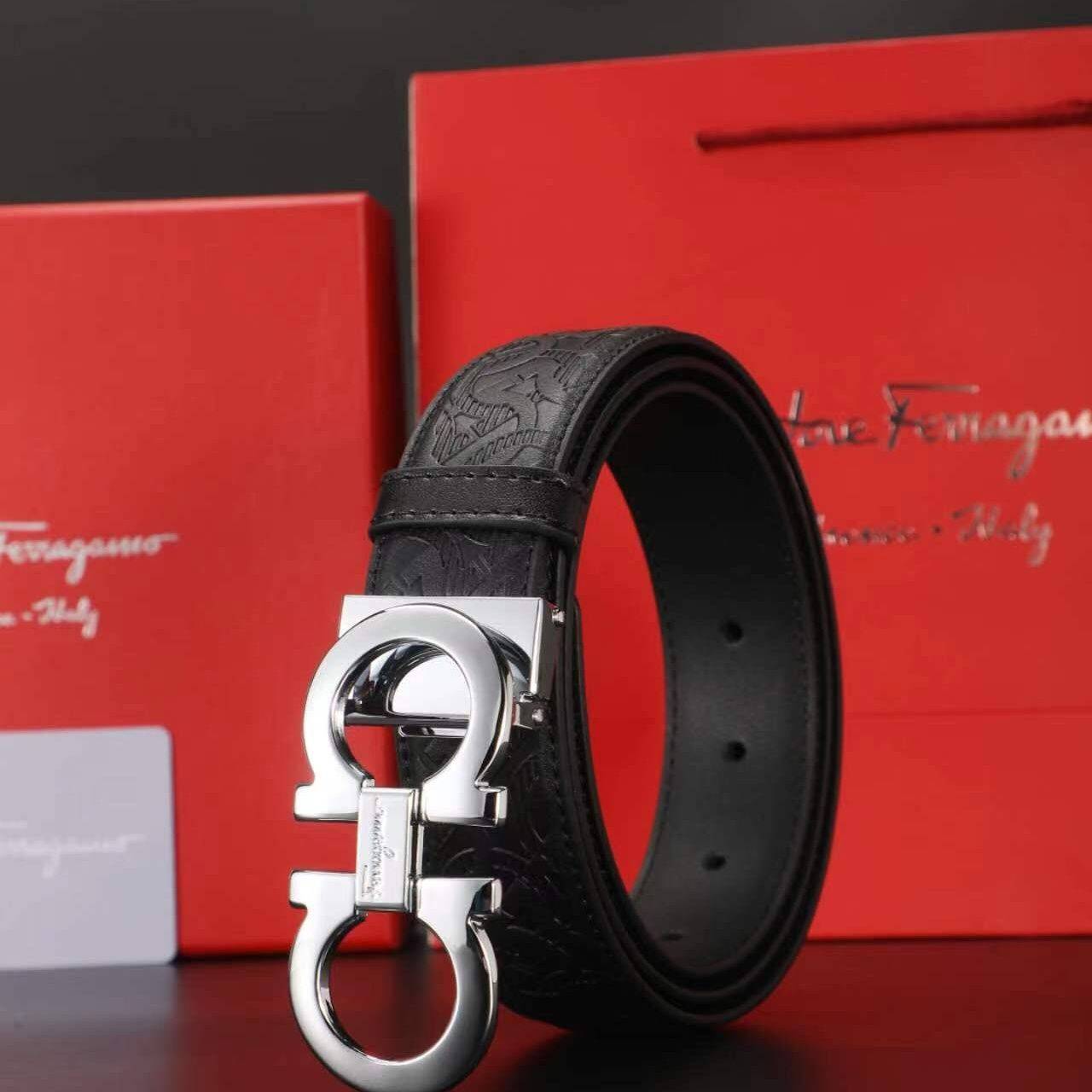 A silver button box with a big horseshoe. 110