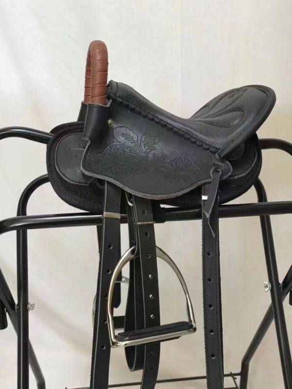 A saddled saddled up on the ground, a saddled saddled saddled up with a folded saddled horse