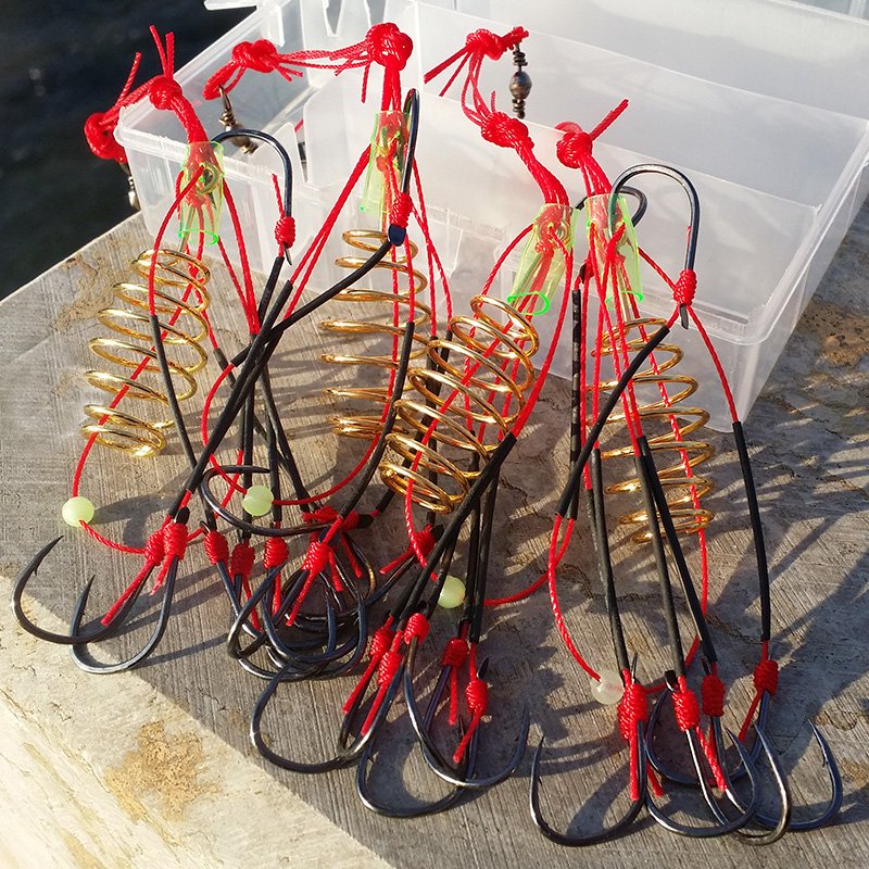 A fishing pole, an IZeni blast hook, a black hole, a bottom-covered hook, a set of fittings
