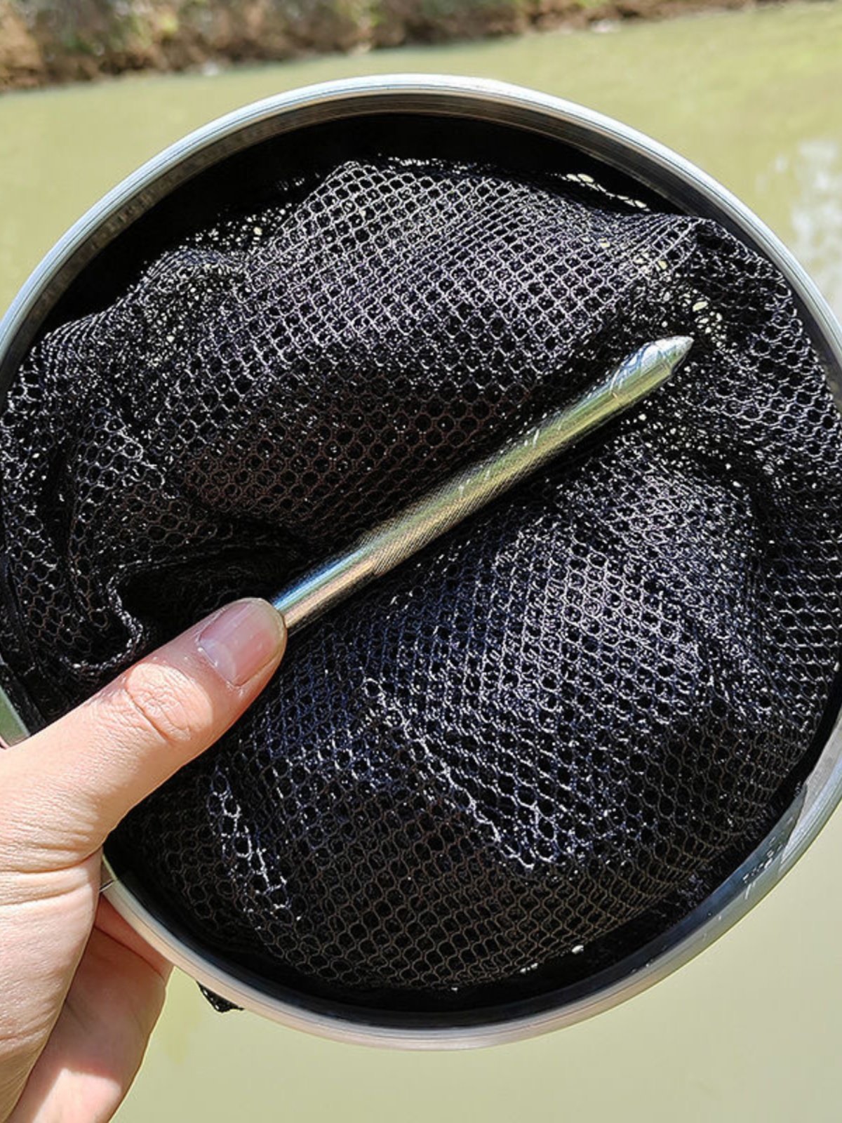 The mini-brook small-eye net folds and carries us out to fish in the middle of the river
