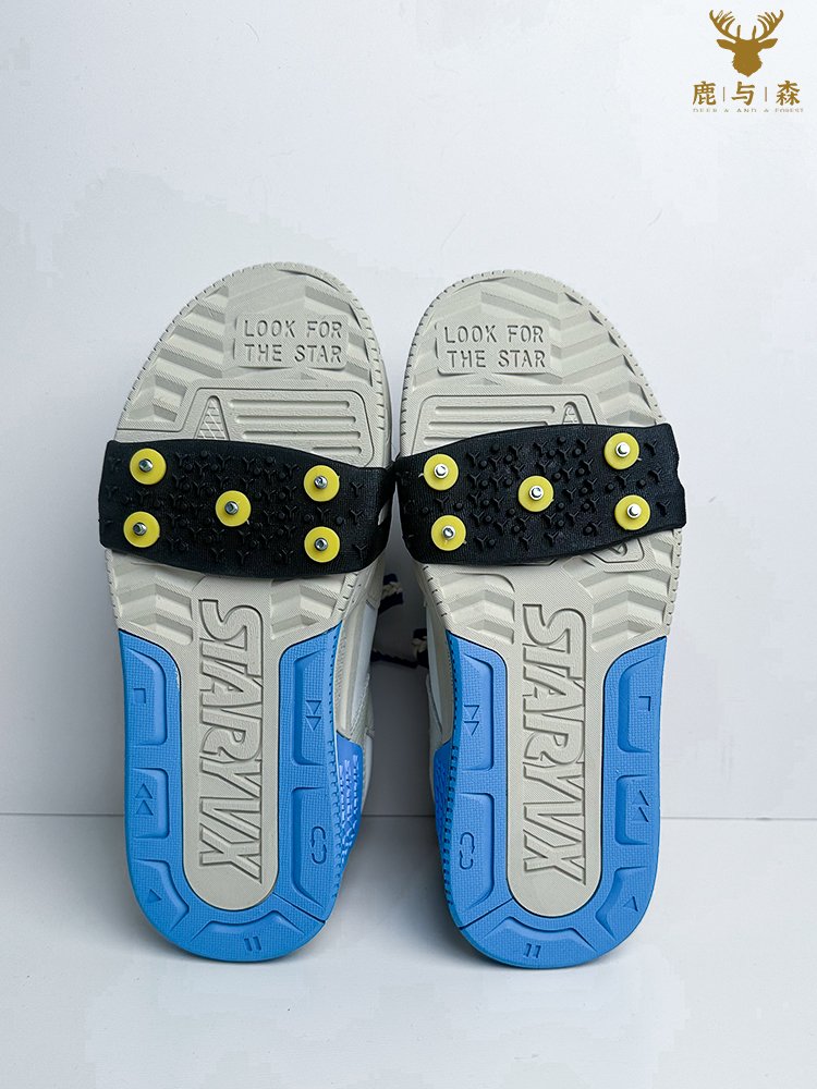 Outdoor shoes with simple ice-clawed shoes nailed to an old man's snow-clawed child against a winter skating machine