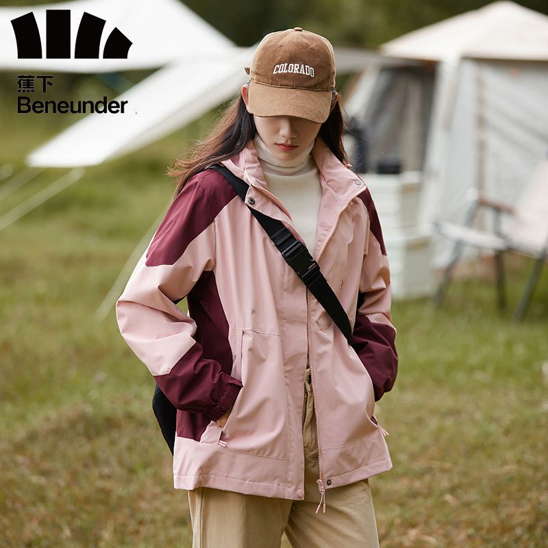 The man with the new camping coat for the autumn and winter went into hiding for the mountaining couple
