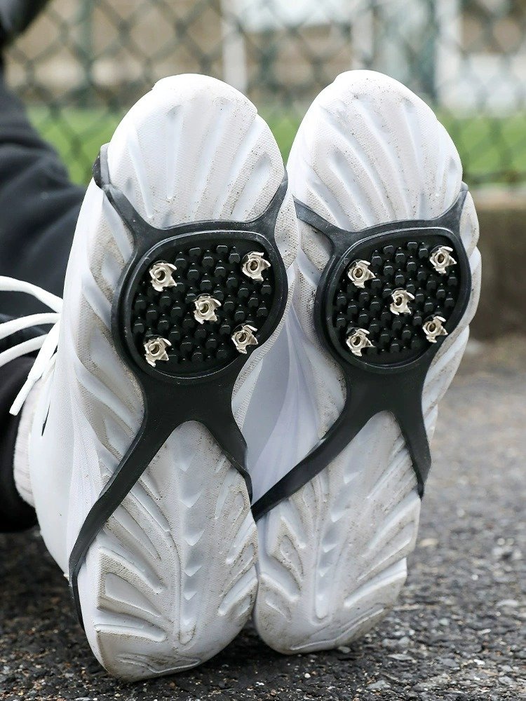 Winter ice claws against snow-shoes on the outside of the ice