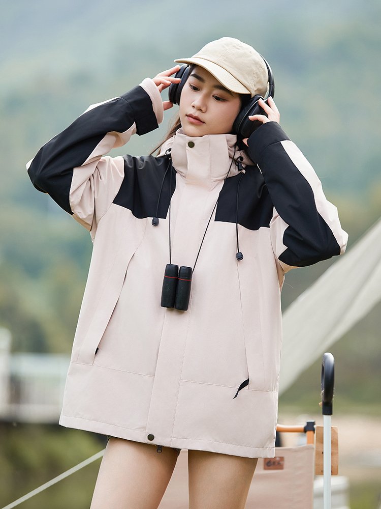 The woman in an outdoor assault suit in one or two pairs of waterproof couple jumpsuits