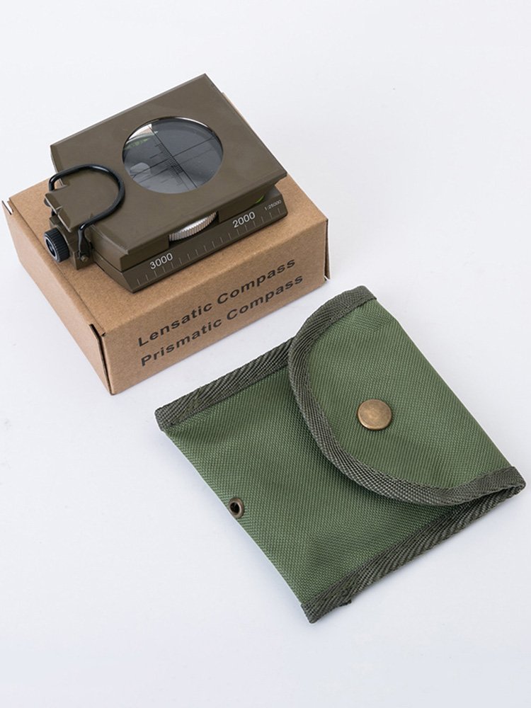 The Chinese-American multifunctional compass points to the north, the outdoor geographer, the slope fluorescent. Photoboard