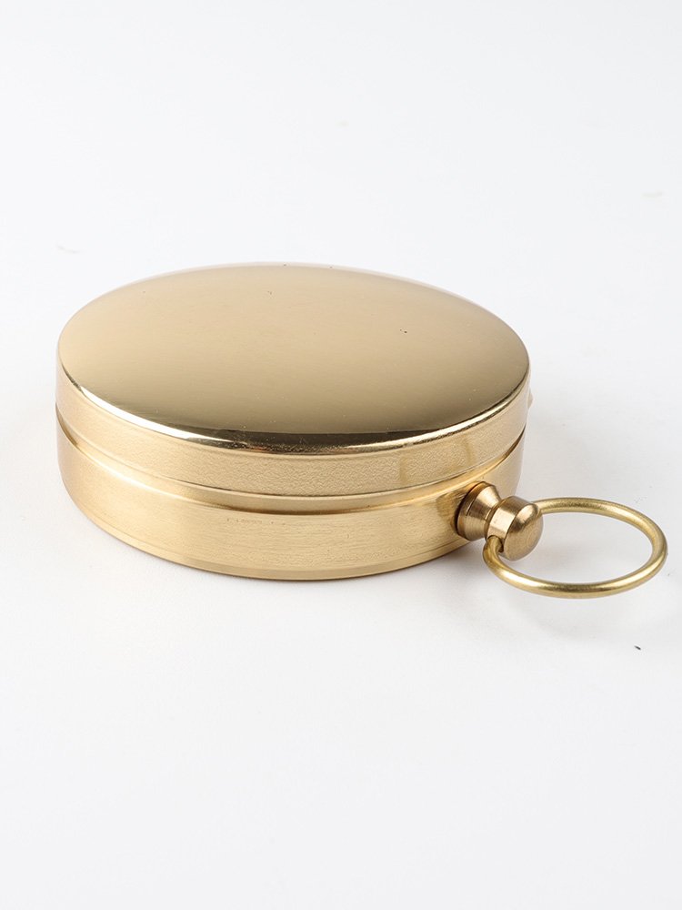 A hand-held compass with a child's high-precision sports climber with a nightlight pointer to the north needle