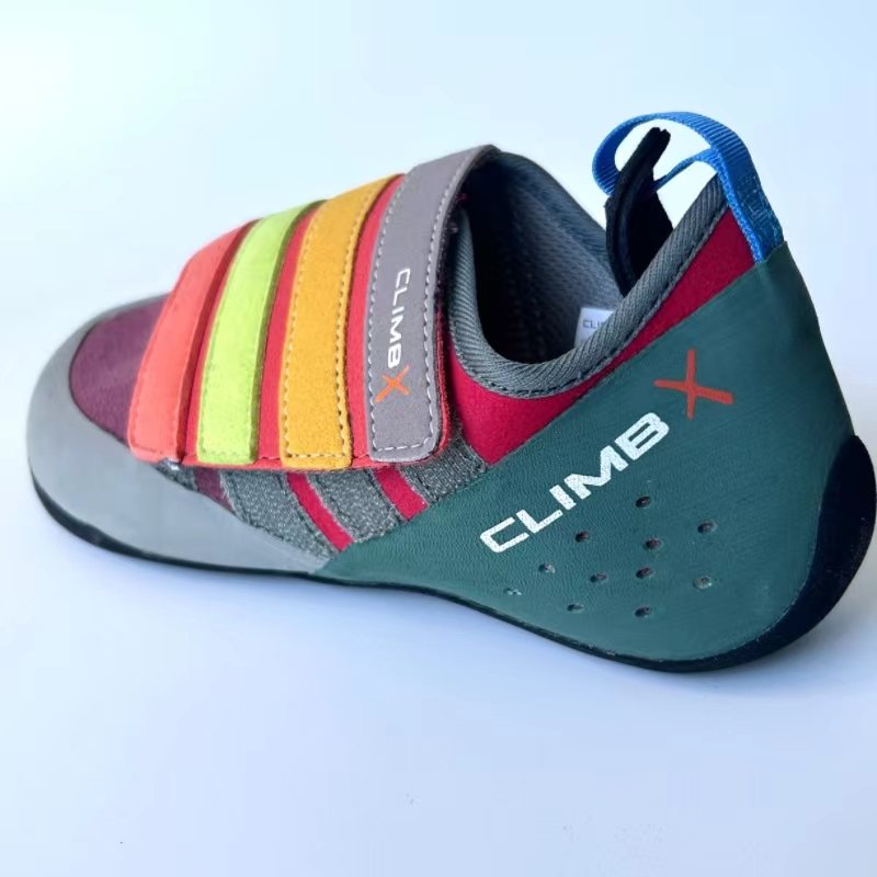 climbx children and young men and women are co-mingled in the rainbow series of climbing shoes and training in the open