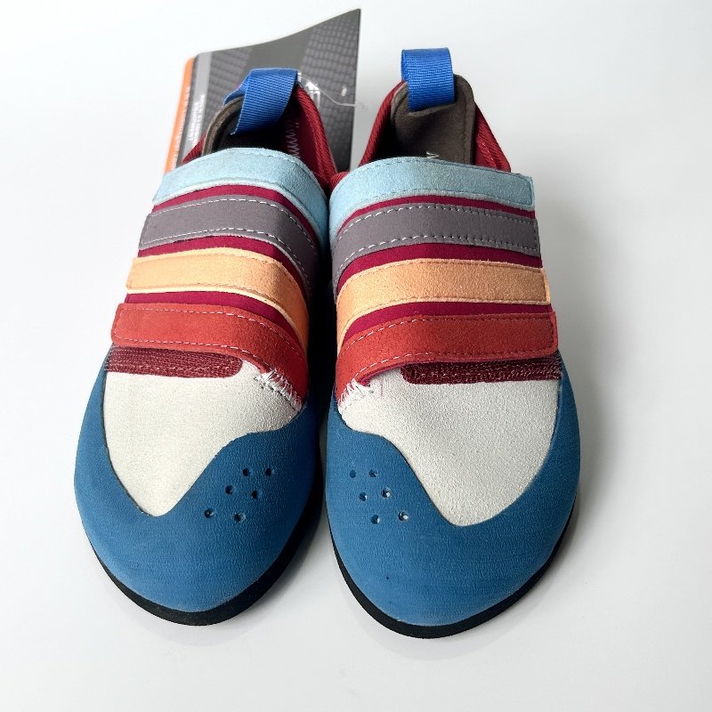 climbx children and young men and women are co-mingled in the rainbow series of climbing shoes and training in the open