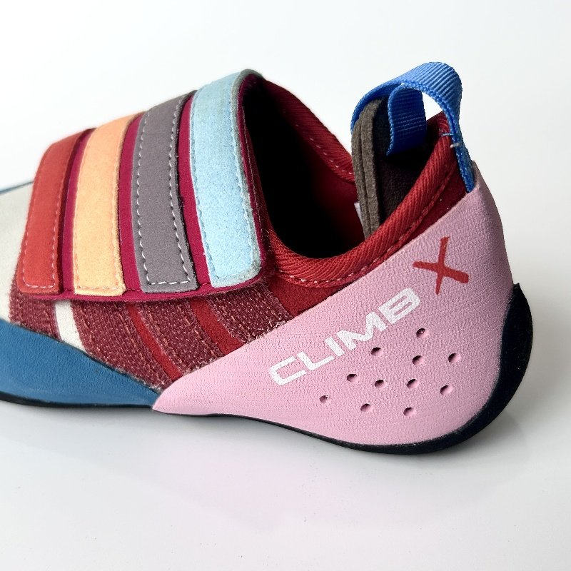 climbx children and young men and women are co-mingled in the rainbow series of climbing shoes and training in the open