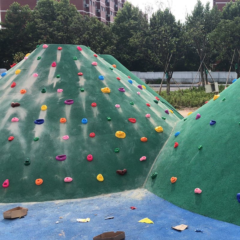 Children climbing out of the rocks, climbing indoors of rock-crawling points with little resin, climbing rock ice grabpers