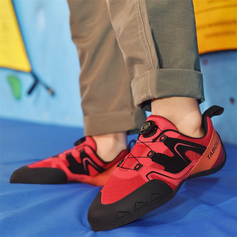 A man and a woman specializing in rock-climbing and climbing outside of their shoes, training in the first stone-crowding room