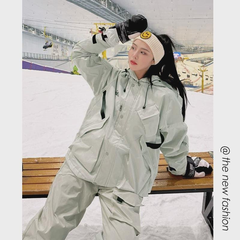 A man and a man with a nice couple skiing suit, a waterproof port, a pocket full of bags, a big warm jacket