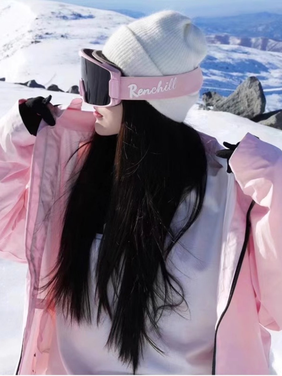 An outdoor ski suit, a man and a woman with a single, loose coat with a pair of ski pants