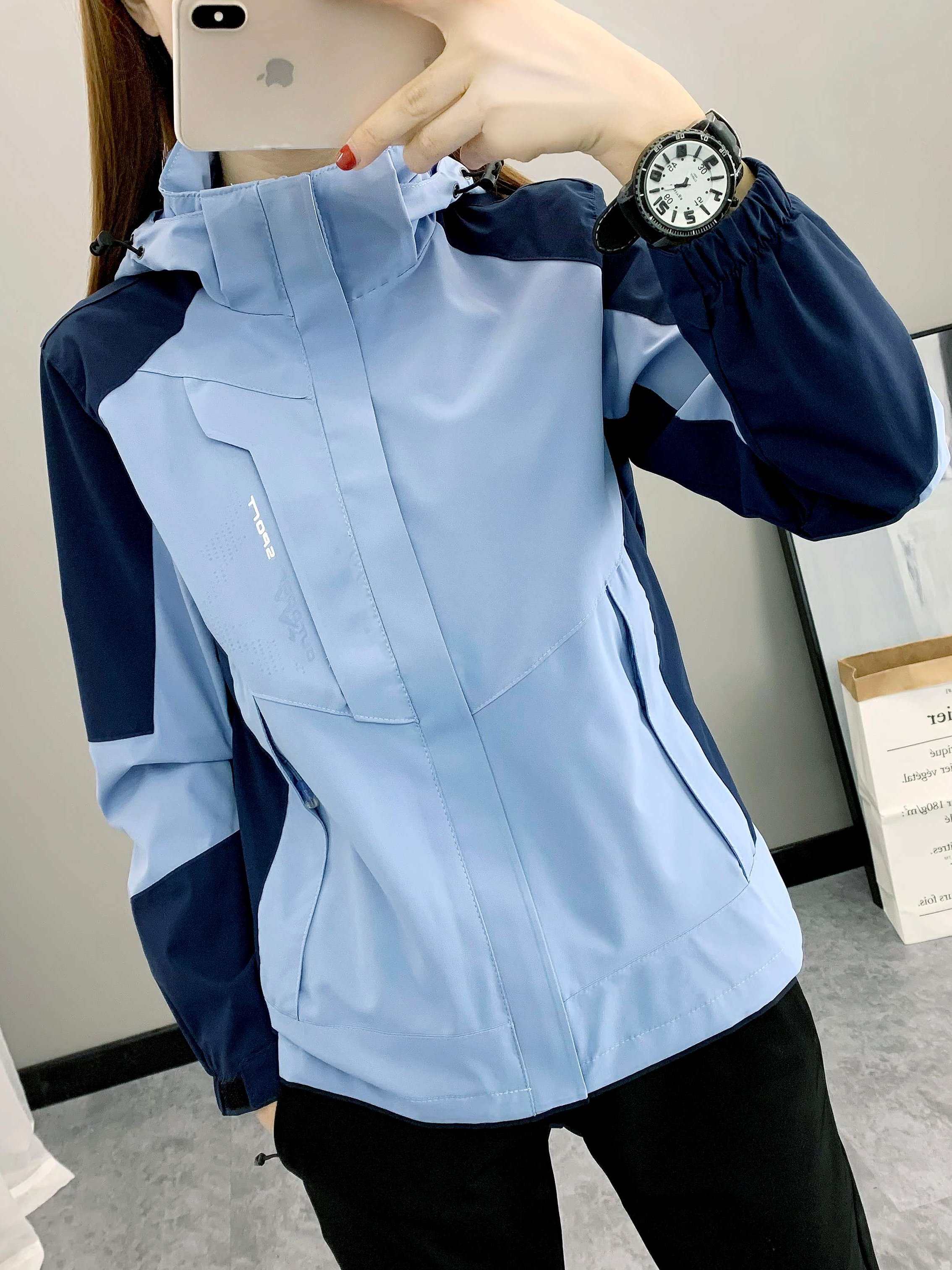 The three-in-one woman in a Phil's T-shirt can take off two pairs of velvet jackets