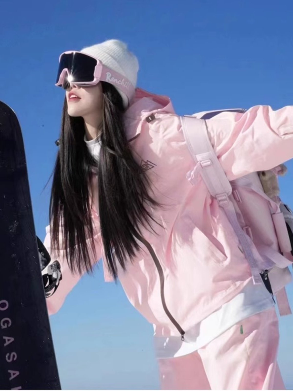 An outdoor ski suit, a man and a woman with a single, loose coat with a pair of ski pants