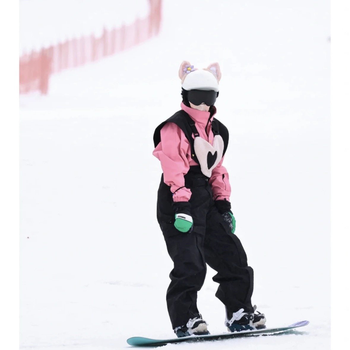 The long white hill skis are rented, the love is a ski suit, the wind is protected