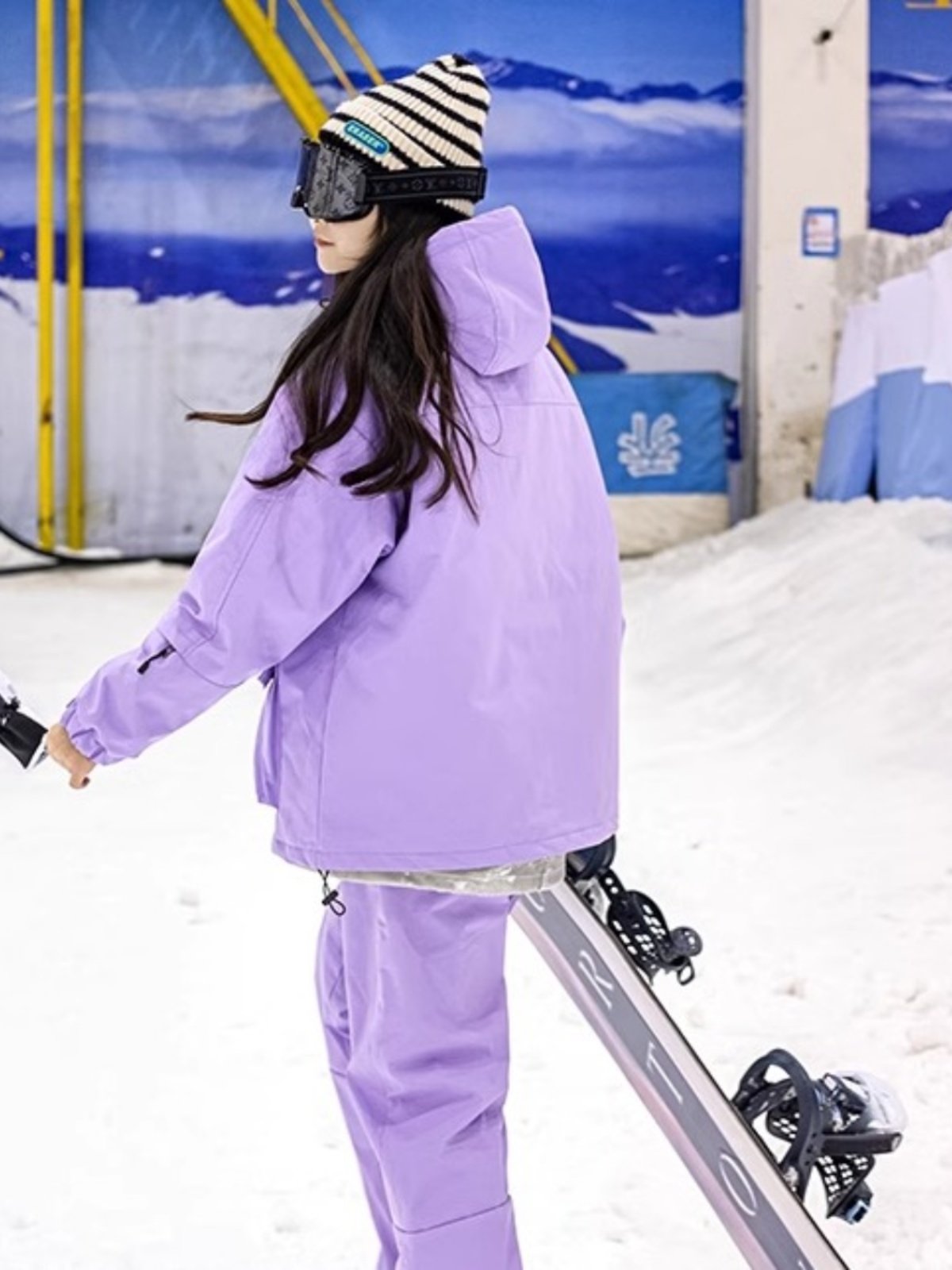 An outdoor ski suit, a man and a woman with a single, loose coat with a pair of ski pants