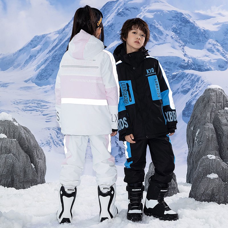 Children in ski suits with girls and boys in ski pants, winter wind-proof sheets, double-board skis