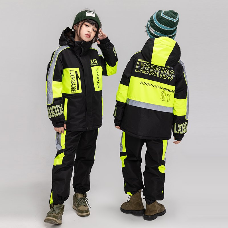 Children in ski suits with girls and boys in ski pants, winter wind-proof sheets, double-board skis