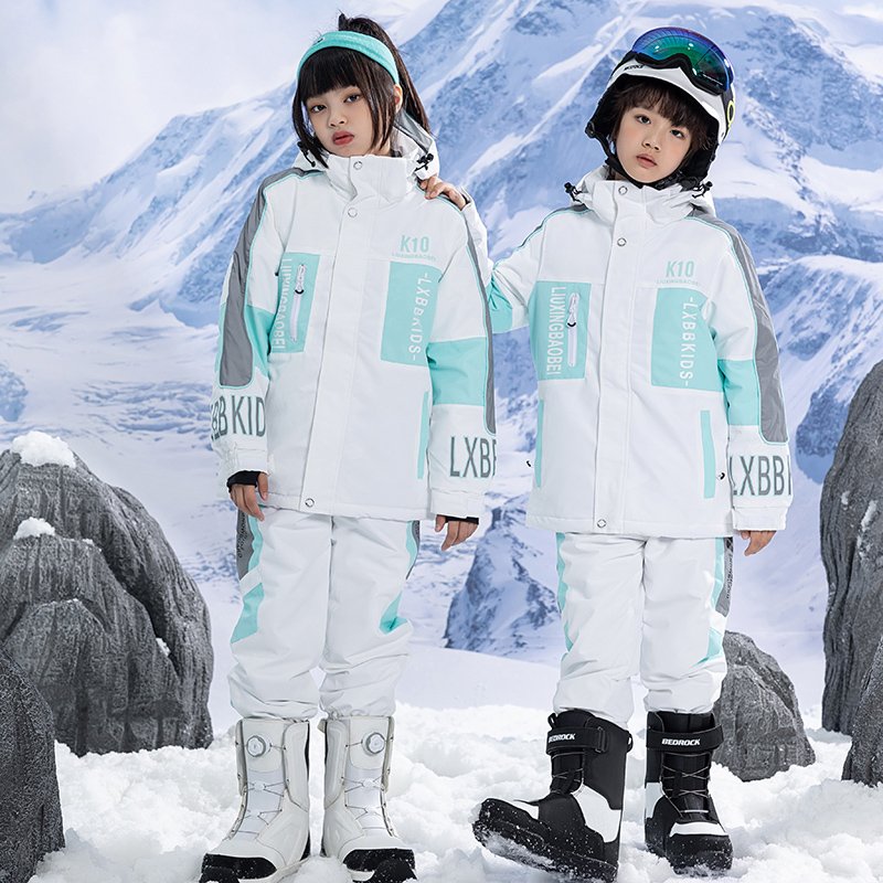 Children in ski suits with girls and boys in ski pants, winter wind-proof sheets, double-board skis