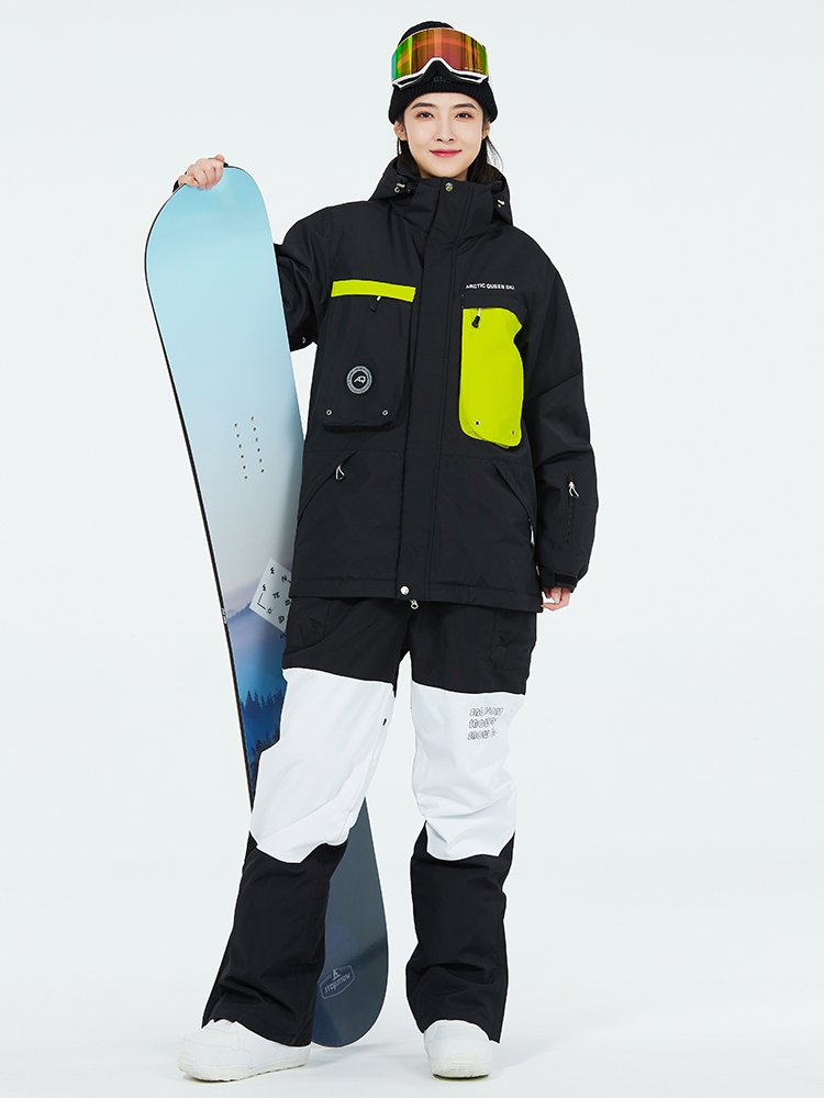 Women in ski suits with men in outdoor weather and waterproof ski pants for winter