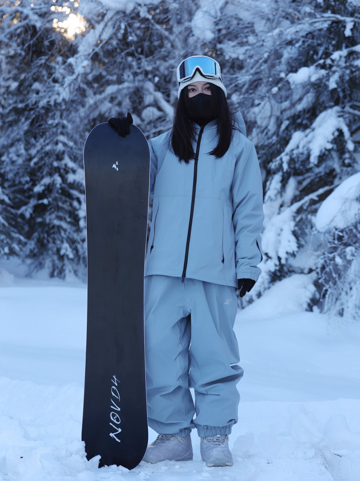 A woman with a new ski suit, double-boarded, full-skinned, waterproof, windproof ski pants