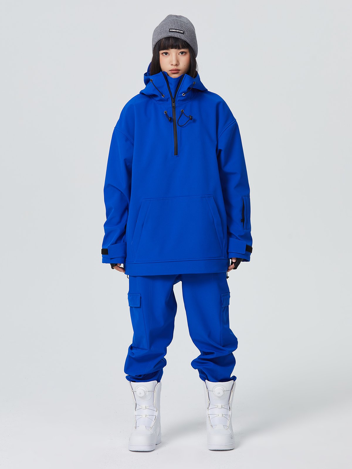 A man and a woman with a one-board double hoodie with a ski suit and a waterproof warmer