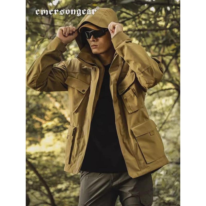 ELMERSON CAY, AN EXTERIOR SKIER, MARCHING TO HIDE A MAN'S HARD-SHELL RAINPROOF M65 WINDSUIT