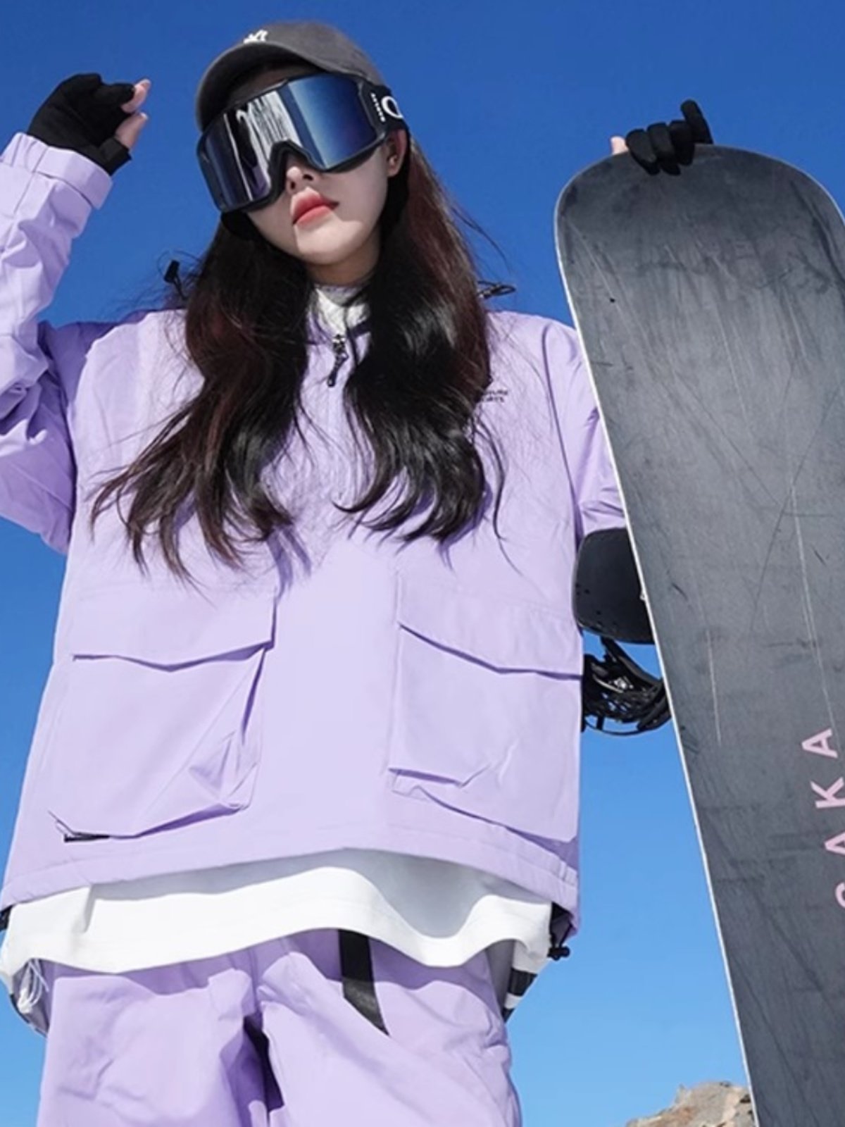An outdoor ski suit, a man and a woman with a single, loose coat with a pair of ski pants