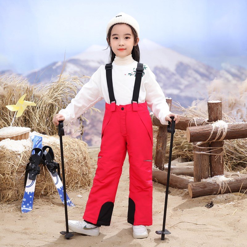 in the children's ski pants, f-boys with ski pants on their backs outside the house, and girls with wind and water-proof, warm-skinned cotton