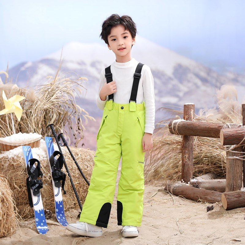 in the children's ski pants, f-boys with ski pants on their backs outside the house, and girls with wind and water-proof, warm-skinned cotton