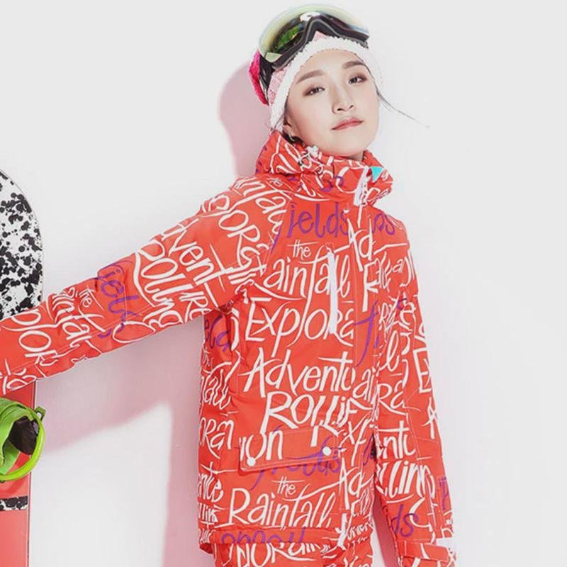 A woman in a ski suit with an adult outside to climb the mountain to protect herself from cold clothes and warm air