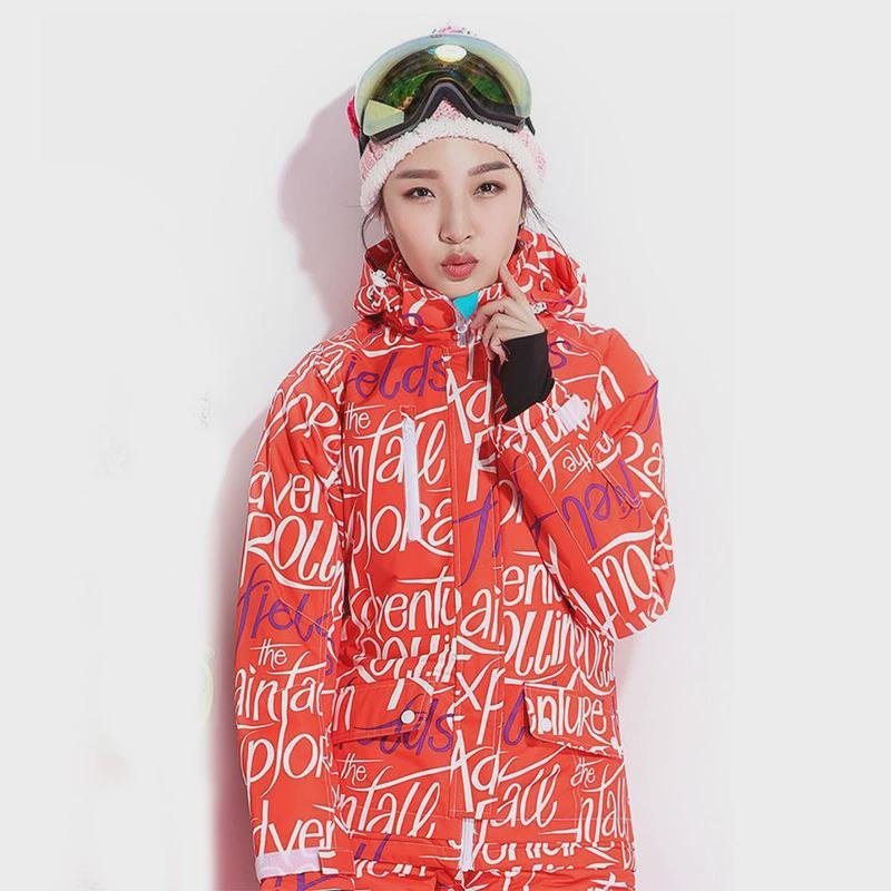 A woman in a ski suit with an adult outside to climb the mountain to protect herself from cold clothes and warm air