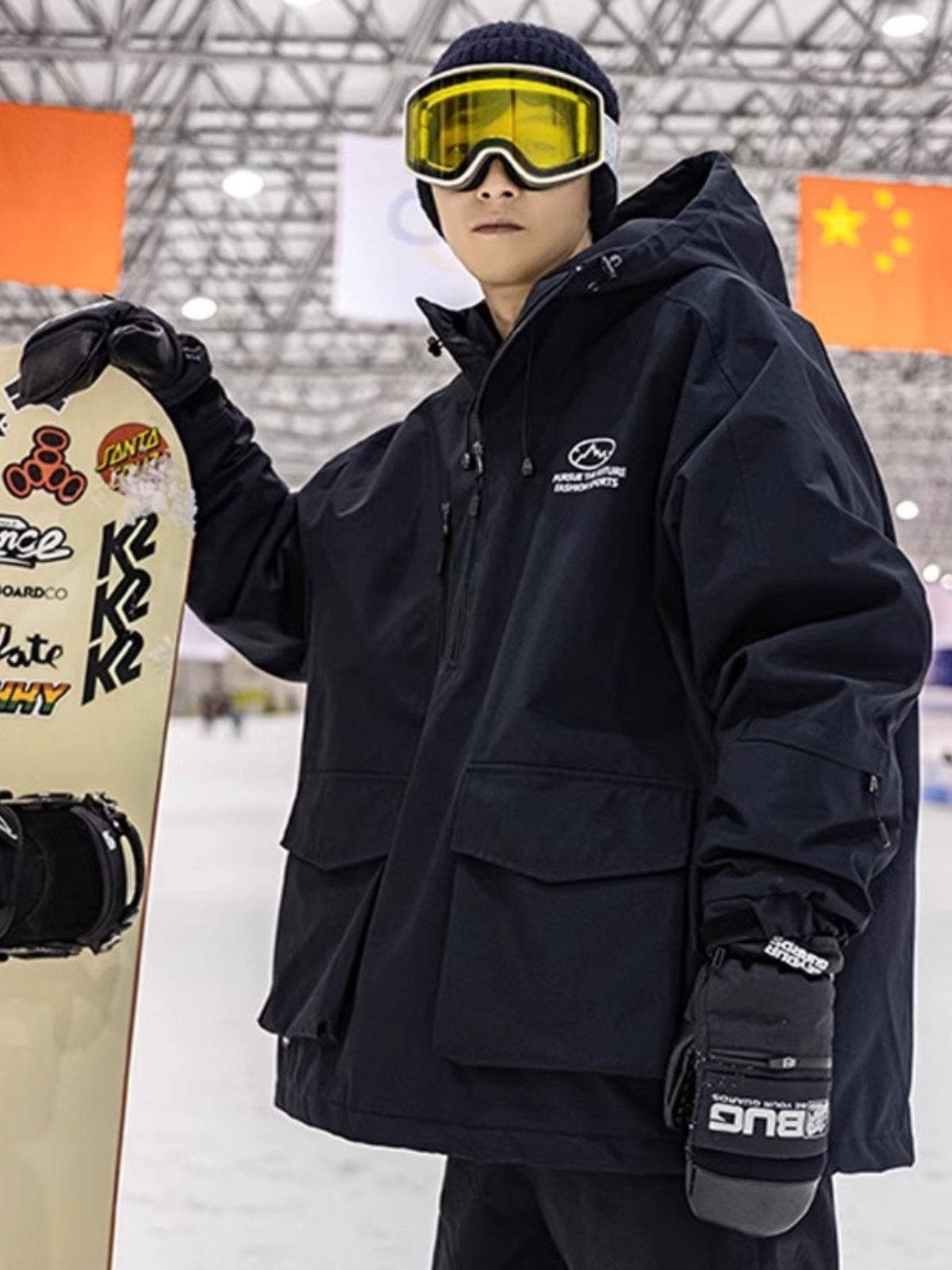 An outdoor ski suit, a man and a woman with a single, loose coat with a pair of ski pants