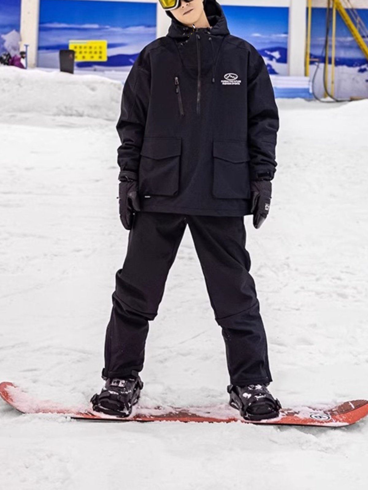 An outdoor ski suit, a man and a woman with a single, loose coat with a pair of ski pants