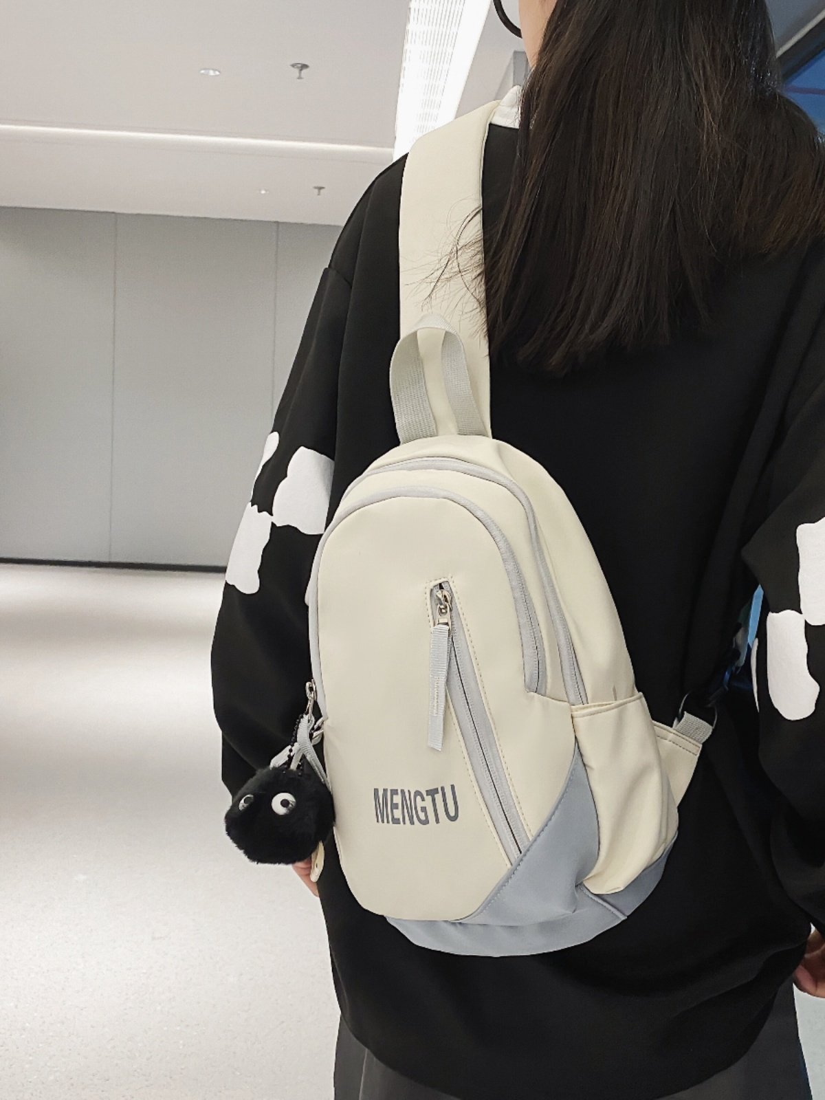 A man with a slant bag of twigs and a man with a one-shoulder backpack with a full-capacity sports troupe