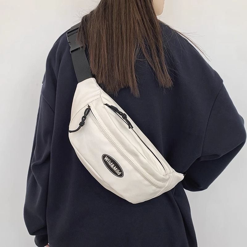 A slashy-packed man's phone rides his waist and hands on a one-shoulder backpack and a one-size-fits-all