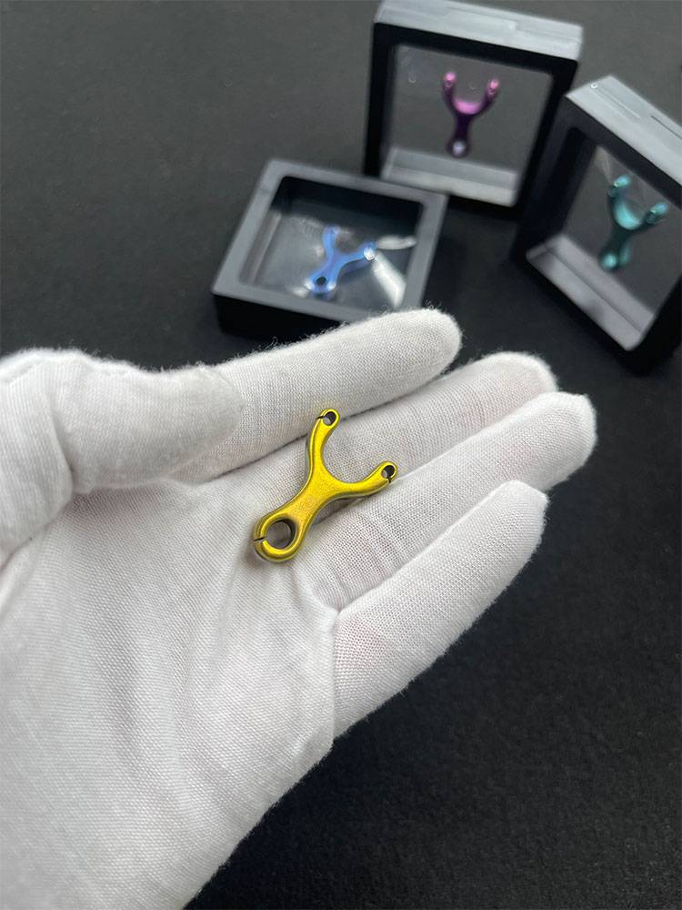 Titium Alloy mini slingshots with a number-crashed line cut in the small hand plate with a mini slingshot