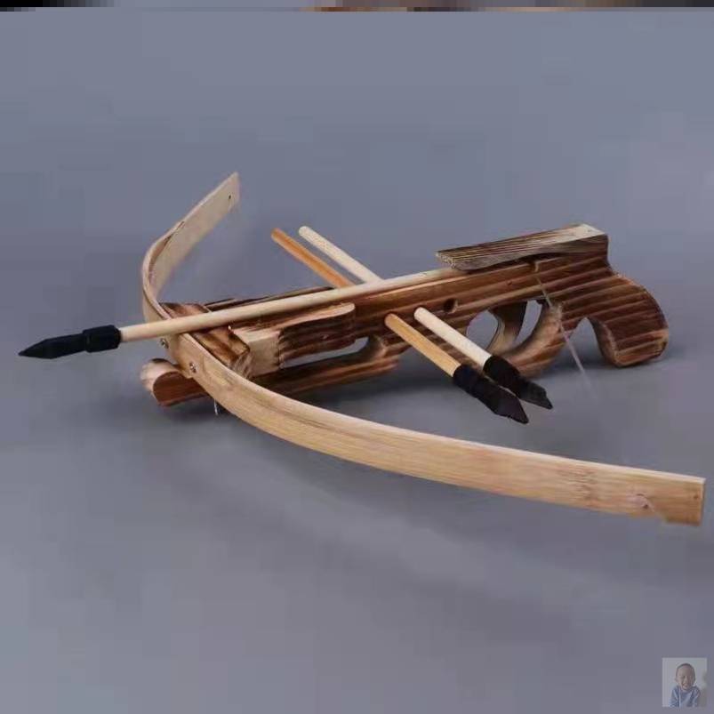 A child outside the house with a crossbow weapon, high-precision, solid-wood mini-crosser toy
